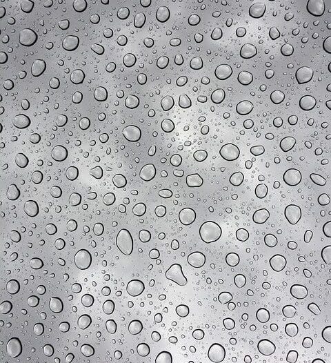 Close-up of water/condensation on the inside of silver ductwork.