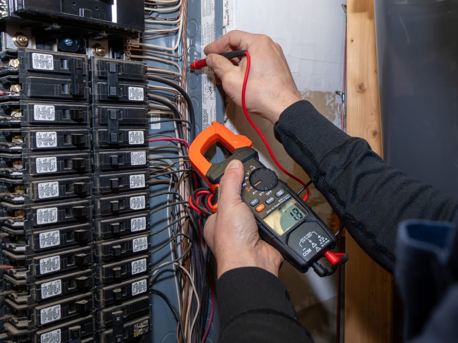 Technician installing and testing a circuit breaker.