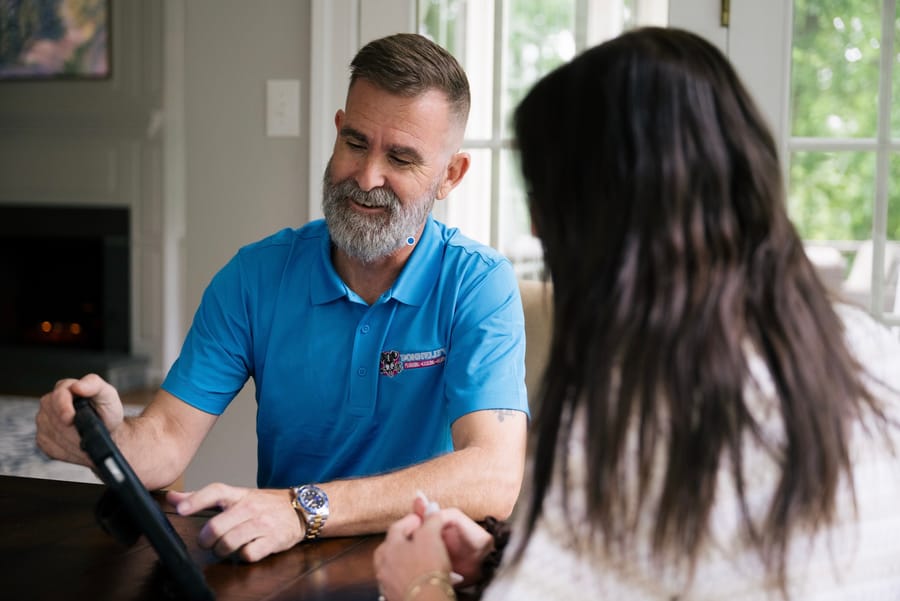Electrician showing customer an iPad screen.