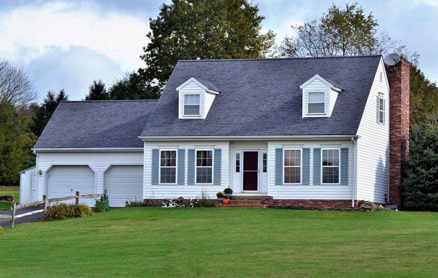 Small white cottage in peaceful setting. Semi rural or suburban area.